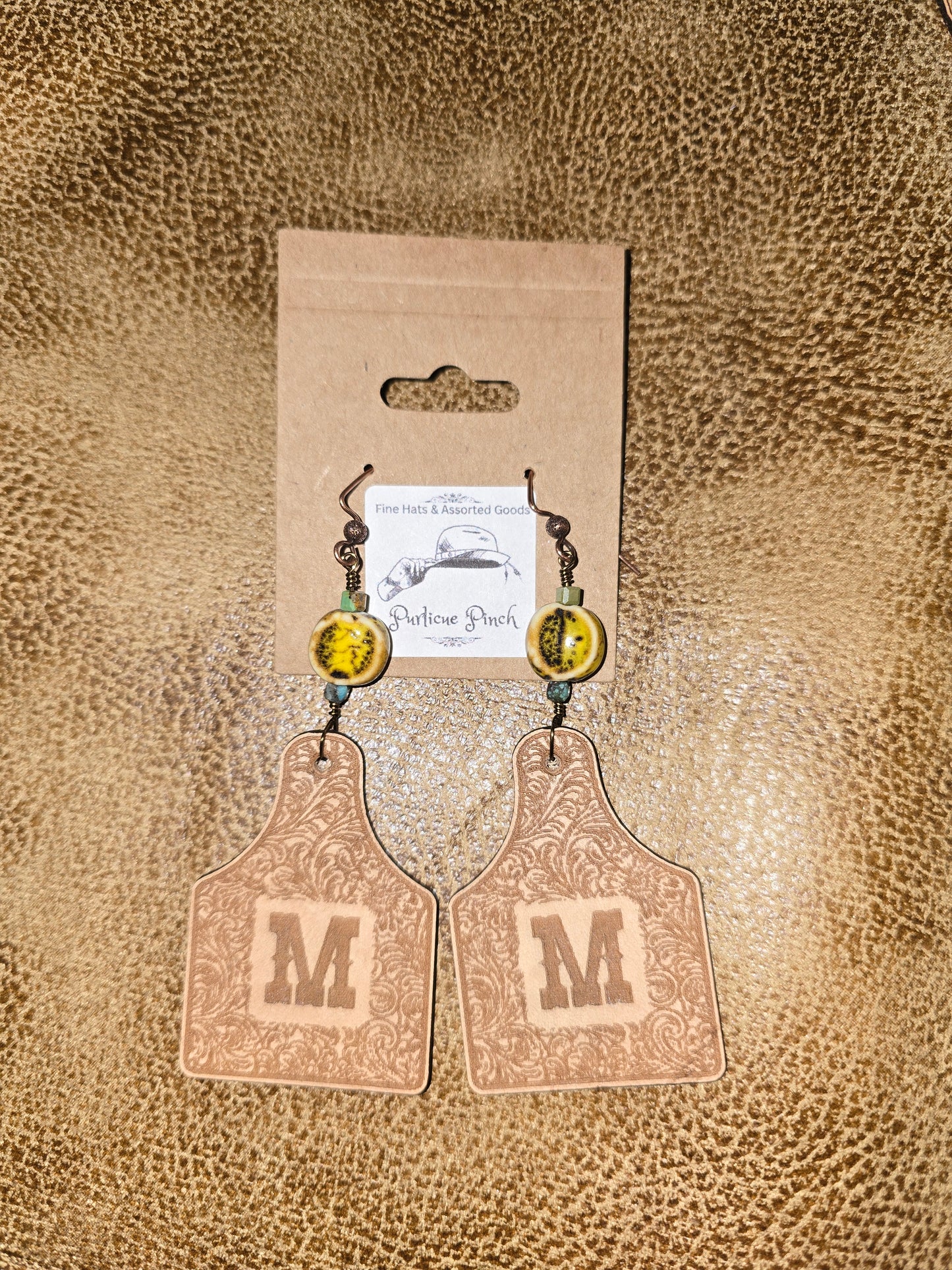Burned Leather Cow Tag Earrings with Initial “M” and Rustic Clay Beads