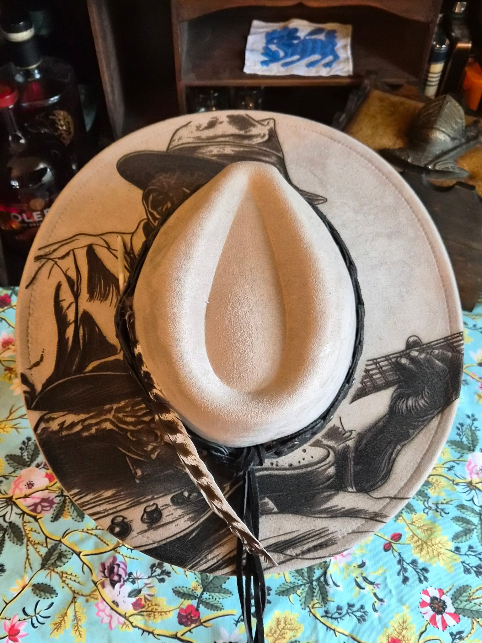 Faux suede wide brim rancher hat with laser-etched Bluesman design, top view showing full brim artwork