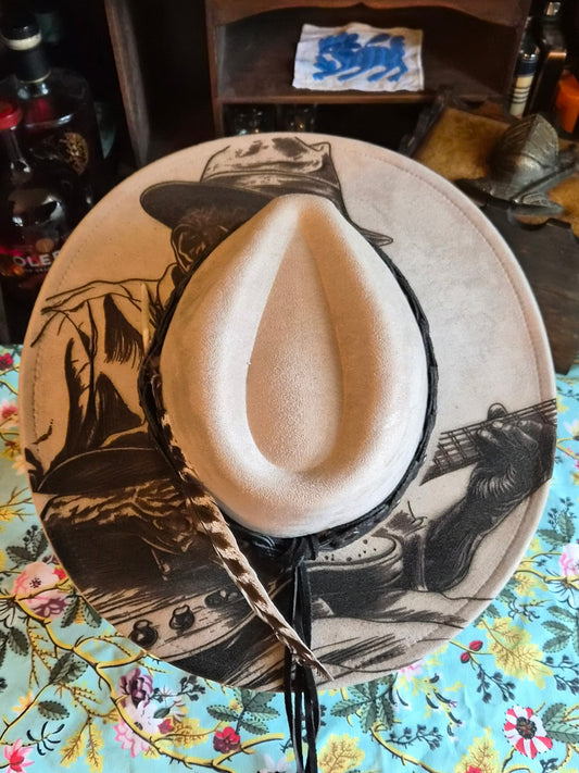 Faux suede wide brim rancher hat with laser-etched Bluesman design, top view showing full brim artwork