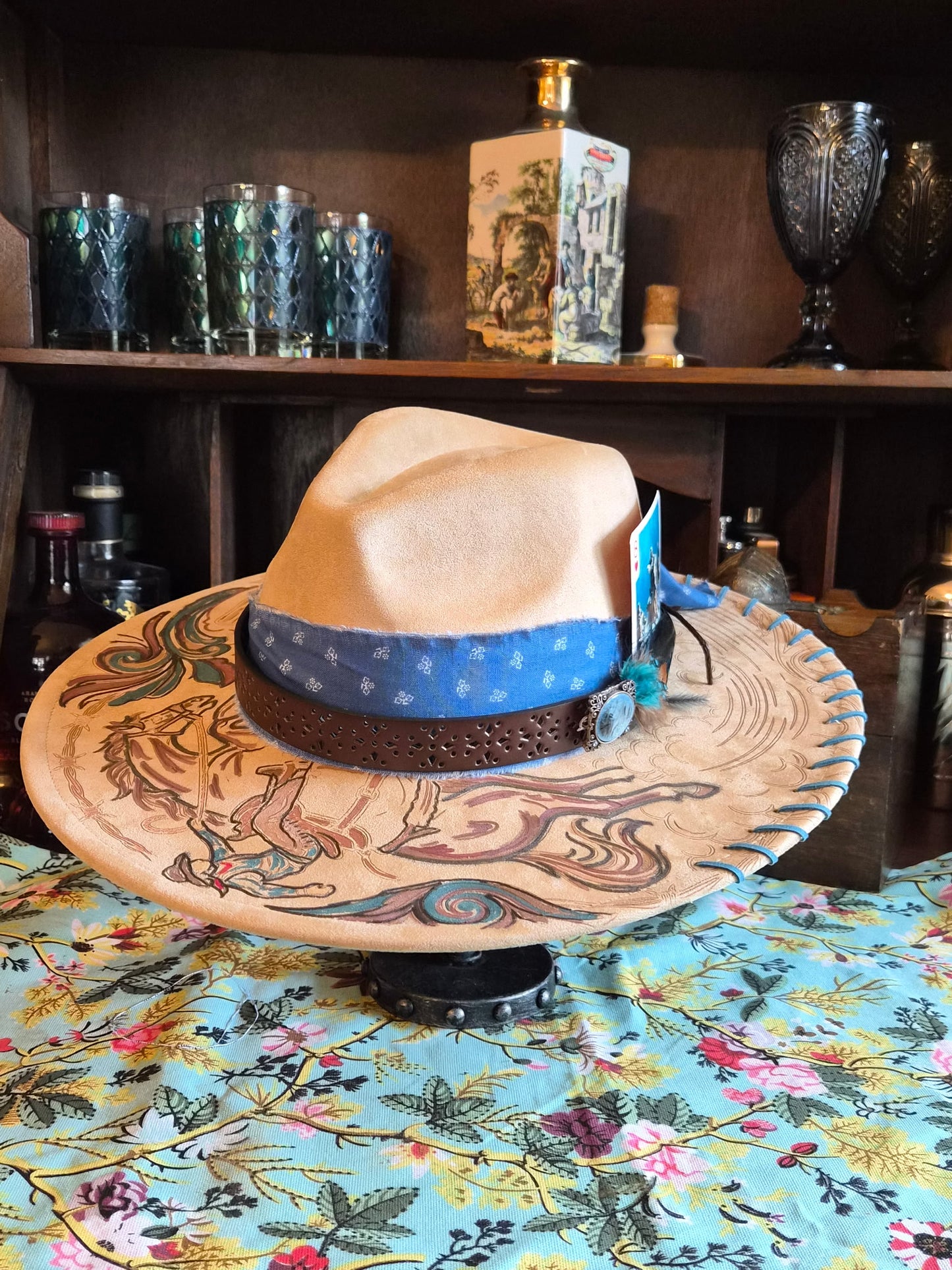 Faux suede wide brim rancher with hand-painted rodeo cowboy laser design, side view
