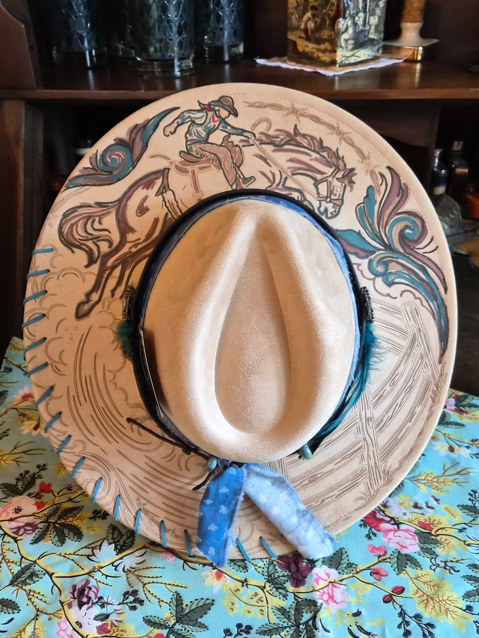 Faux suede wide brim rancher with hand-painted rodeo cowboy laser design, top view showing full brim artwork