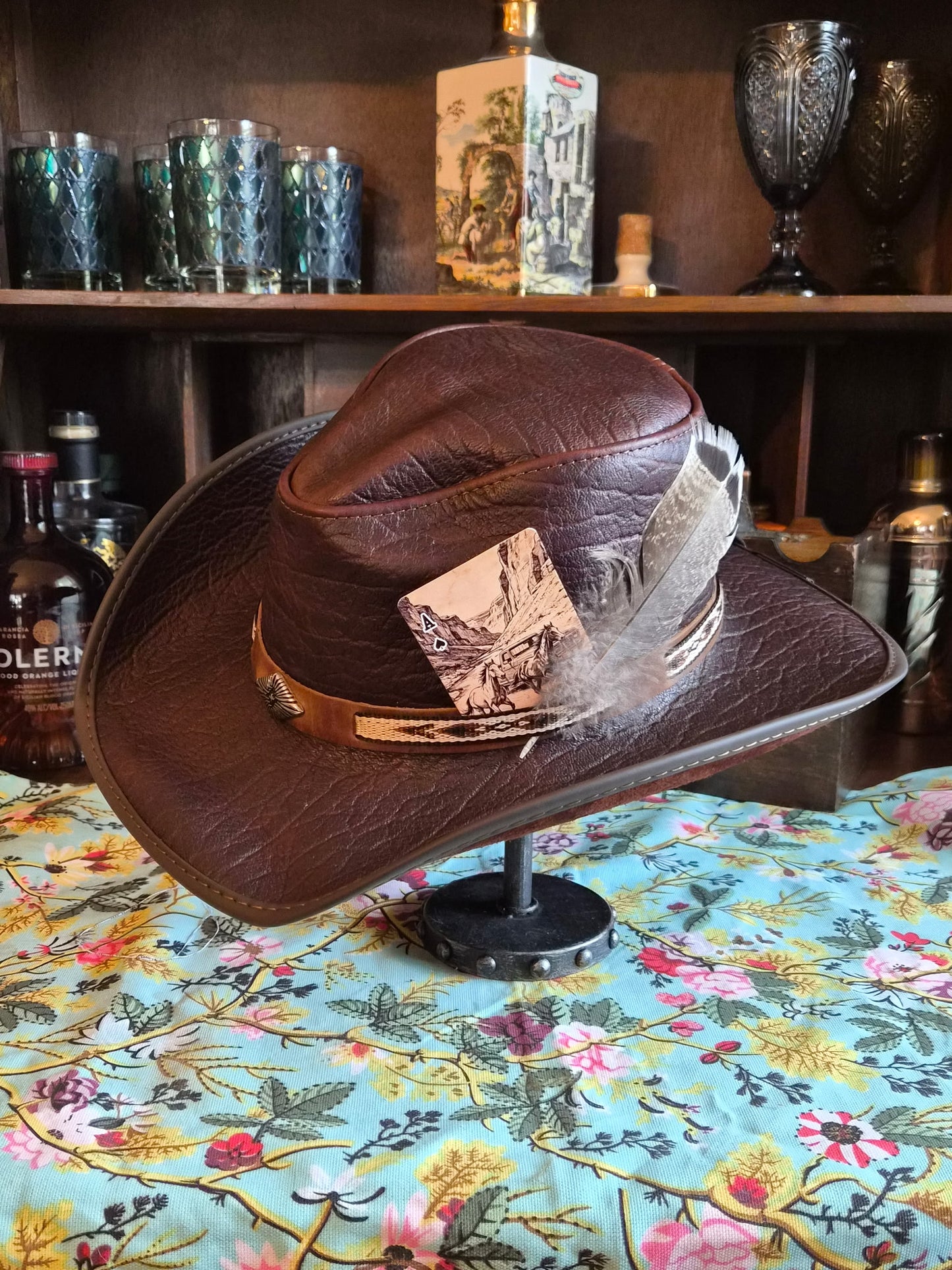 Dark brown all leather cowboy hat size L with slim hatband, concho, and western scene patch